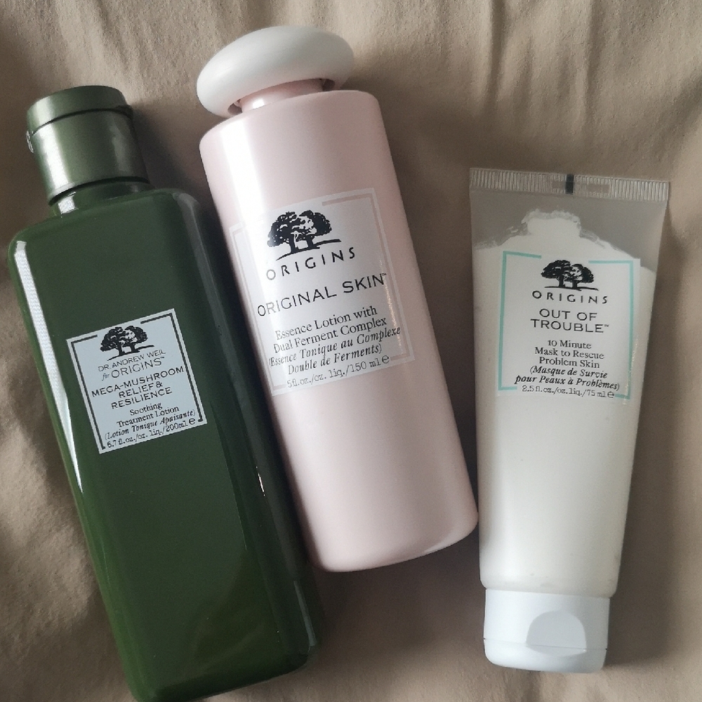 Origins Skincare Set with Green, Pink, and White Bottles